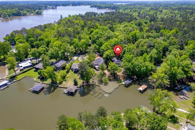 drone / aerial view featuring a forest view and a water view