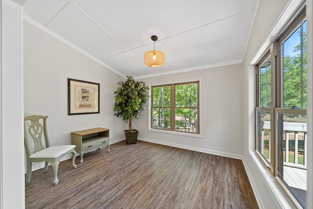 sitting room featuring vaulted ceiling, wood finished floors, crown molding, and baseboards