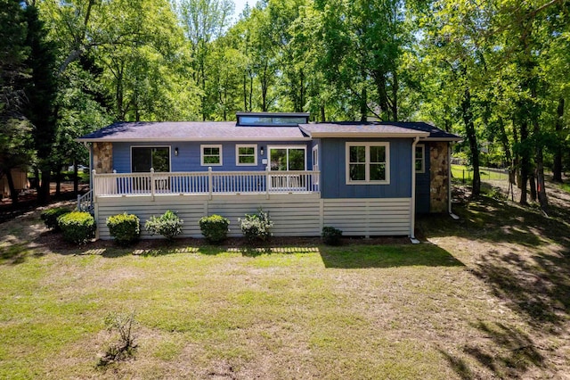 view of front of property with board and batten siding and a front yard