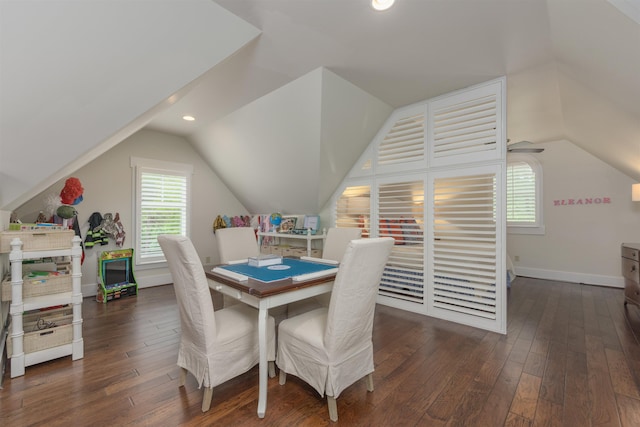 dining area featuring dark wood-type flooring and lofted ceiling