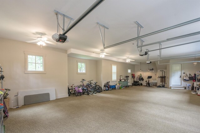 garage featuring ceiling fan and a garage door opener