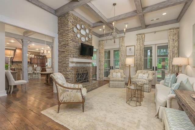 living room featuring a notable chandelier, wood-type flooring, and french doors