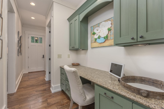 office area featuring built in desk and dark hardwood / wood-style flooring