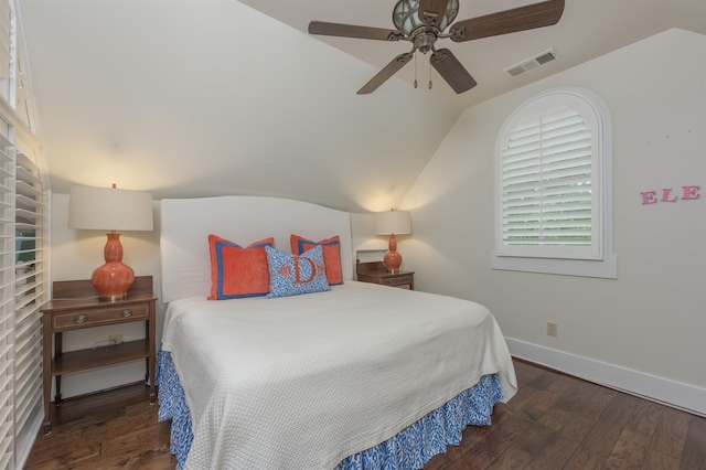 bedroom featuring dark hardwood / wood-style flooring, vaulted ceiling, and ceiling fan