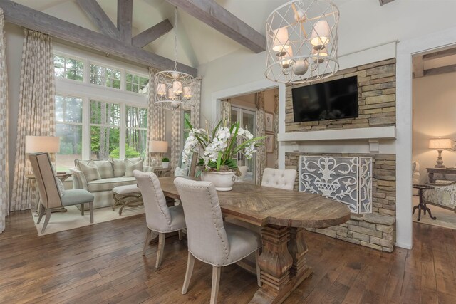 dining area with hardwood / wood-style floors, a fireplace, high vaulted ceiling, and a chandelier