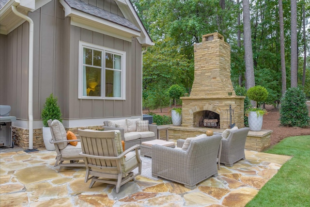 view of patio / terrace with an outdoor living space with a fireplace