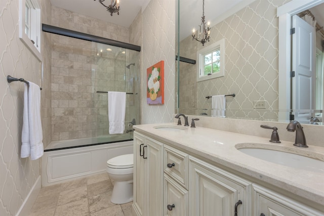 full bathroom featuring enclosed tub / shower combo, vanity, a notable chandelier, and toilet