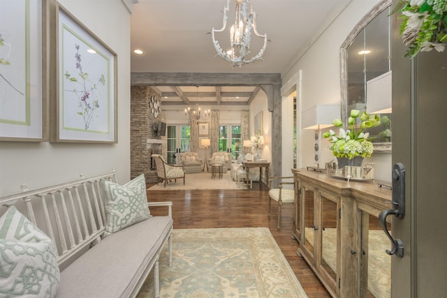 interior space with hardwood / wood-style flooring, coffered ceiling, a chandelier, and beamed ceiling