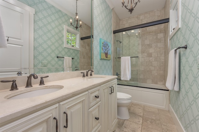 full bathroom featuring vanity, a notable chandelier, shower / bath combination with glass door, and toilet