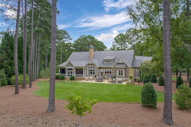 rear view of property with an outdoor hangout area, a lawn, and a patio area