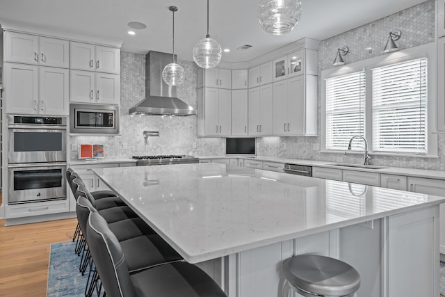 1101 Brookside, Greensboro, GA 30642 - kitchen with appliances with stainless steel finishes, wall chimney exhaust hood, a sink, and white cabinets