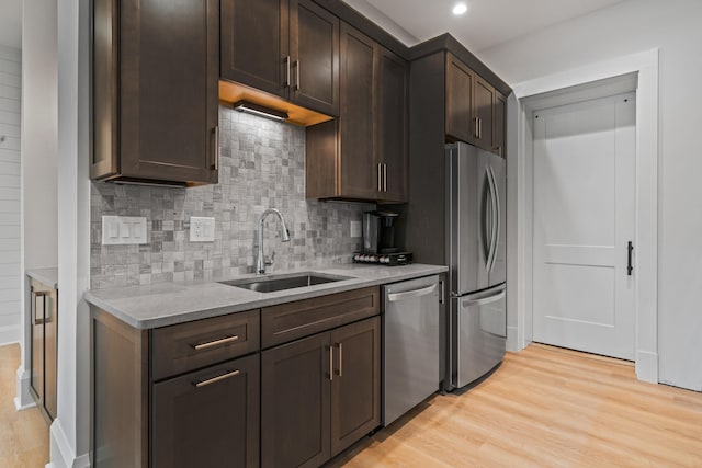 1101 Brookside, Greensboro, GA 30642 - kitchen with dark brown cabinetry, a sink, stainless steel appliances, and light wood-style floors