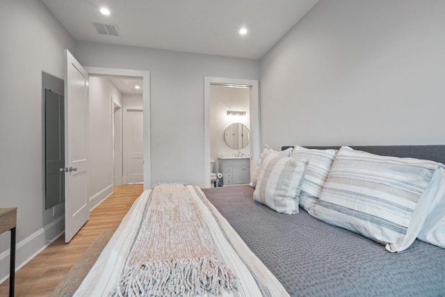1101 Brookside, Greensboro, GA 30642 - bedroom featuring light wood finished floors, ensuite bath, visible vents, and recessed lighting