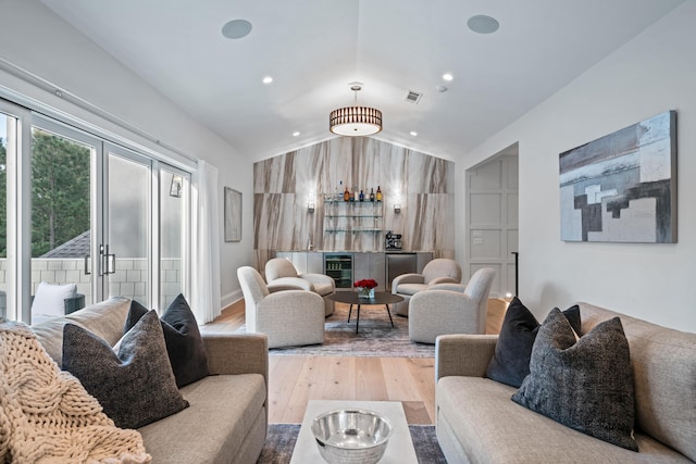 1101 Brookside, Greensboro, GA 30642 - living room featuring vaulted ceiling, wood finished floors, beverage cooler, visible vents, and a dry bar