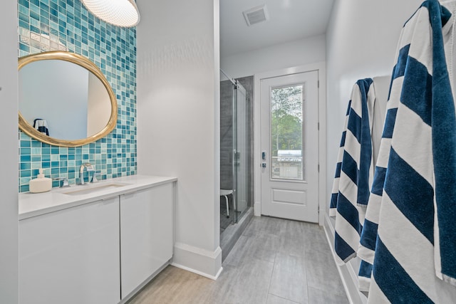 1101 Brookside, Greensboro, GA 30642 - full bath with vanity, a shower stall, tasteful backsplash, baseboards, and visible vents