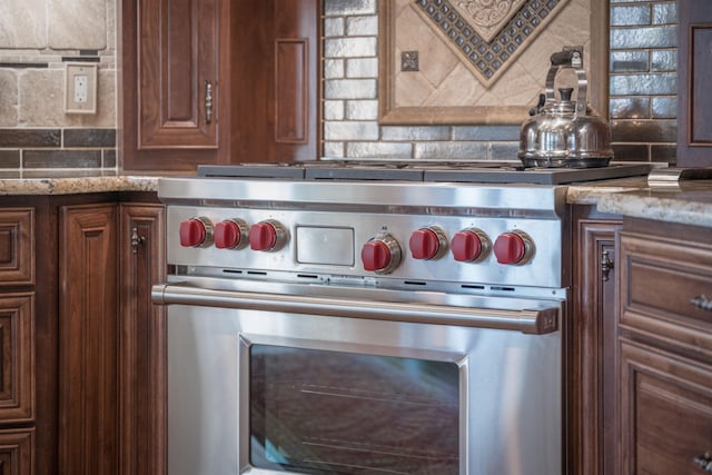 1071 Palmers Vw, Greensboro, GA 30642 - interior details featuring light stone countertops, high end range, and tasteful backsplash