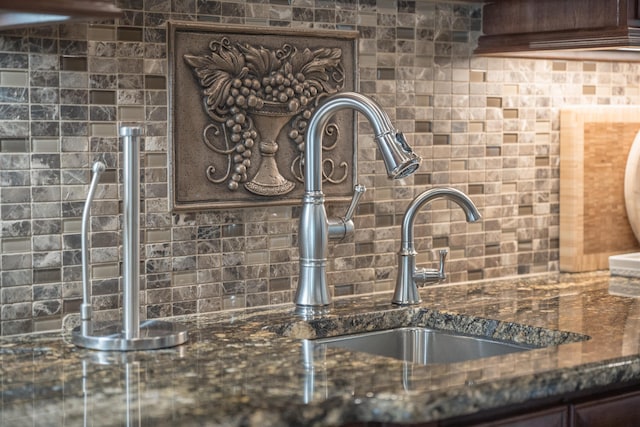 1071 Palmers Vw, Greensboro, GA 30642 - details featuring dark brown cabinetry, dark stone counters, and tasteful backsplash