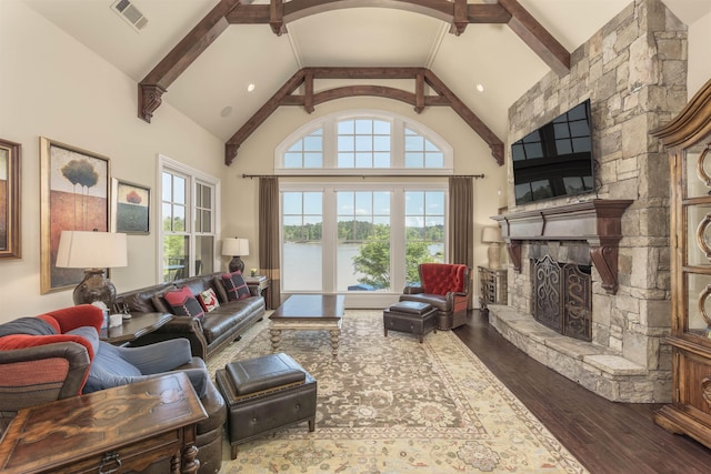 1071 Palmers Vw, Greensboro, GA 30642 - living area featuring high vaulted ceiling, a stone fireplace, hardwood / wood-style flooring, beamed ceiling, and visible vents