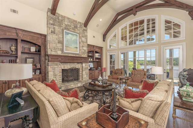 1071 Palmers Vw, Greensboro, GA 30642 - living area featuring a stone fireplace, visible vents, beam ceiling, built in features, and high vaulted ceiling