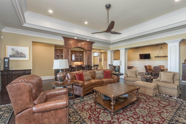 1071 Palmers Vw, Greensboro, GA 30642 - living area with ornate columns, a raised ceiling, wood finished floors, a ceiling fan, and crown molding