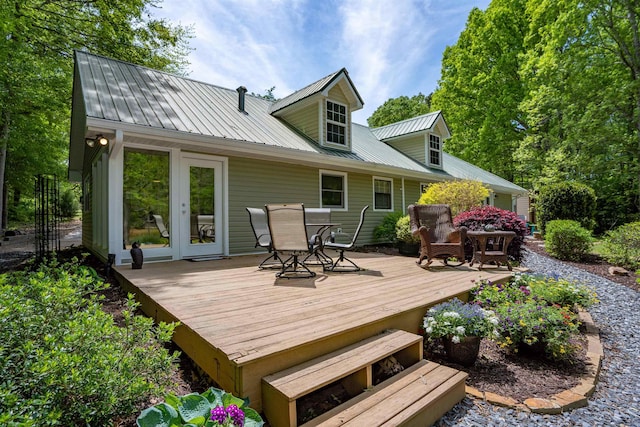 rear view of house with a wooden deck and french doors