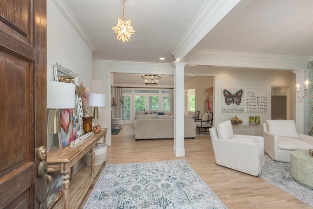 1040 Kimbrough Hill Ln, Greensboro, GA 30642 - foyer with ornamental molding, light wood finished floors, a chandelier, decorative columns, and recessed lighting