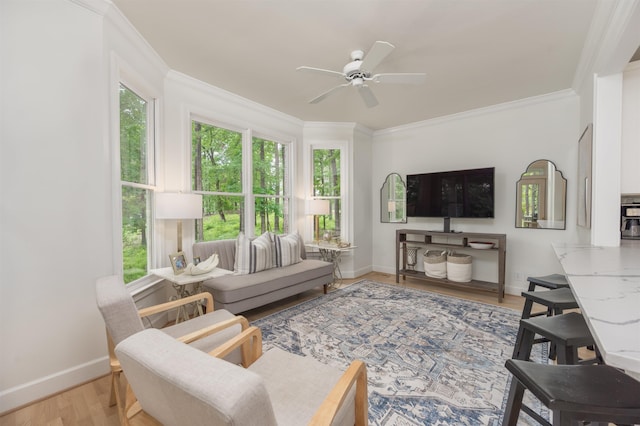 1040 Kimbrough Hill Ln, Greensboro, GA 30642 - living room with baseboards, ceiling fan, light wood-type flooring, and crown molding