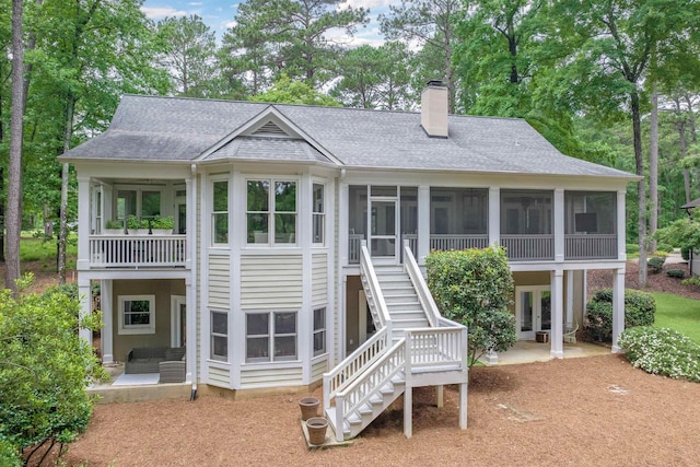 1040 Kimbrough Hill Ln, Greensboro, GA 30642 - back of house with a sunroom, stairway, a chimney, a shingled roof, and a patio area