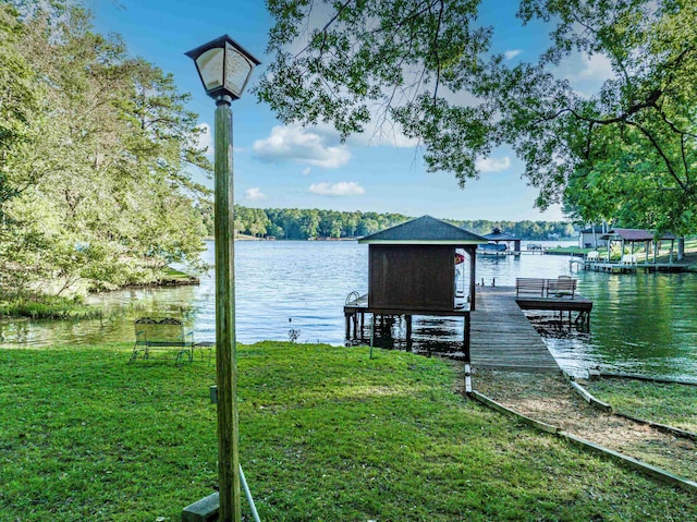 view of dock featuring a yard and a water view