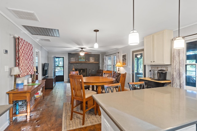 dining area with a ceiling fan, visible vents, dark wood-style flooring, and a healthy amount of sunlight