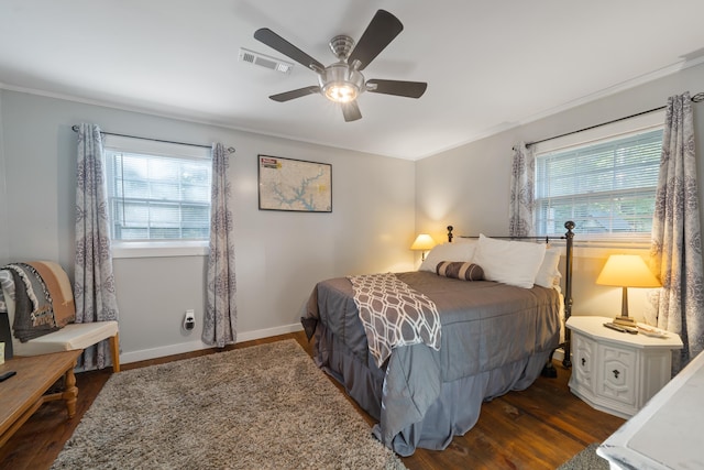 bedroom with dark wood-type flooring, multiple windows, baseboards, and visible vents