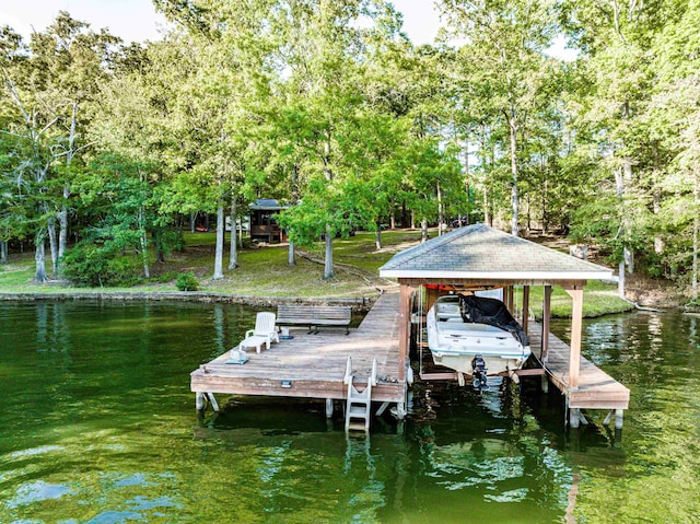 dock area with boat lift and a water view