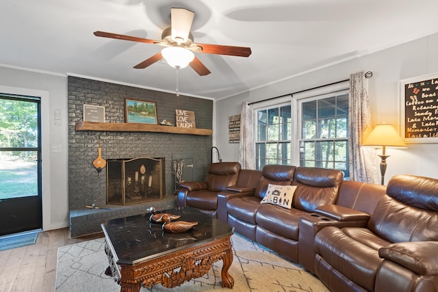 living room featuring a healthy amount of sunlight, crown molding, ceiling fan, and wood-type flooring