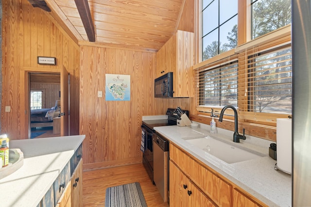 125 Secoffee Dr, Eatonton, GA 31024 - kitchen with a sink, wooden walls, range with electric cooktop, black microwave, and dishwasher