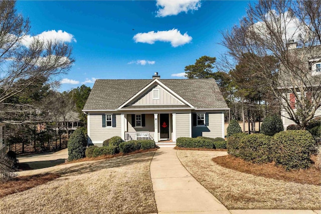 bungalow-style home featuring a porch and a front lawn