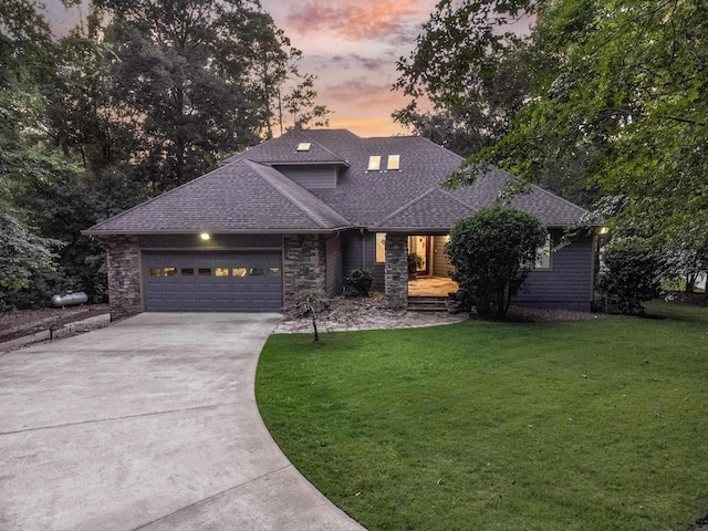 view of front of house featuring a garage and a yard