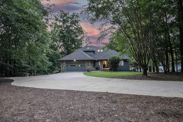 view of front of property featuring a garage and a lawn