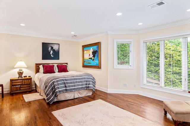 bedroom with dark wood-type flooring and ornamental molding