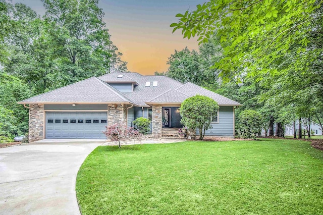 view of front facade with a yard and a garage