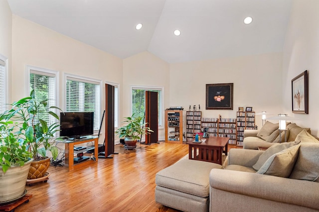 living room featuring vaulted ceiling and light hardwood / wood-style floors