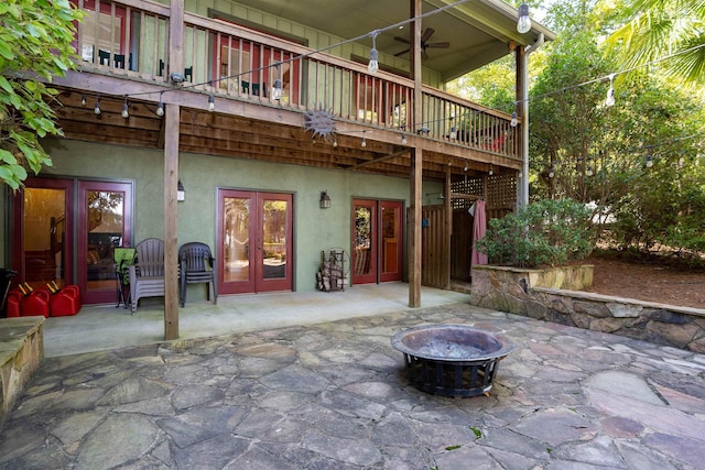 view of patio / terrace with french doors, ceiling fan, and an outdoor fire pit