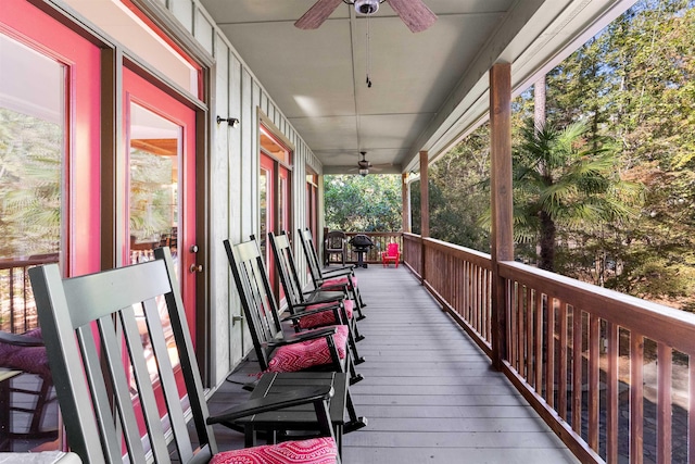 wooden deck with ceiling fan and a porch