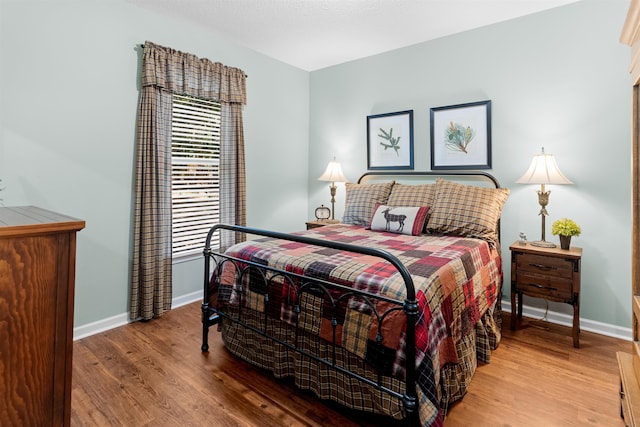 bedroom with wood-type flooring