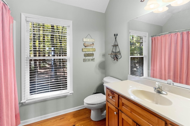 bathroom featuring lofted ceiling, vanity, toilet, and hardwood / wood-style floors