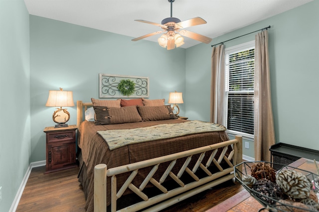 bedroom with dark hardwood / wood-style floors and ceiling fan