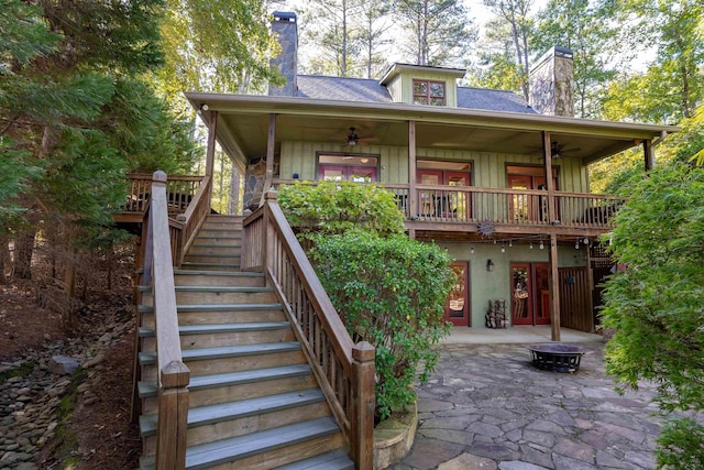 back of property with a patio area, ceiling fan, and an outdoor fire pit