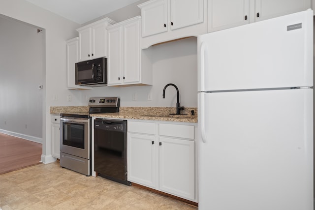 kitchen featuring light stone counters, baseboards, a sink, black appliances, and white cabinetry