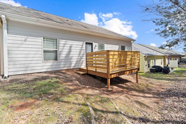 rear view of property with central AC and a wooden deck