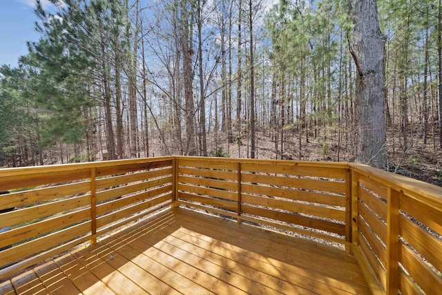 wooden deck with a forest view