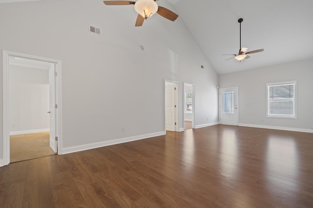 unfurnished living room with visible vents, baseboards, wood finished floors, high vaulted ceiling, and a ceiling fan